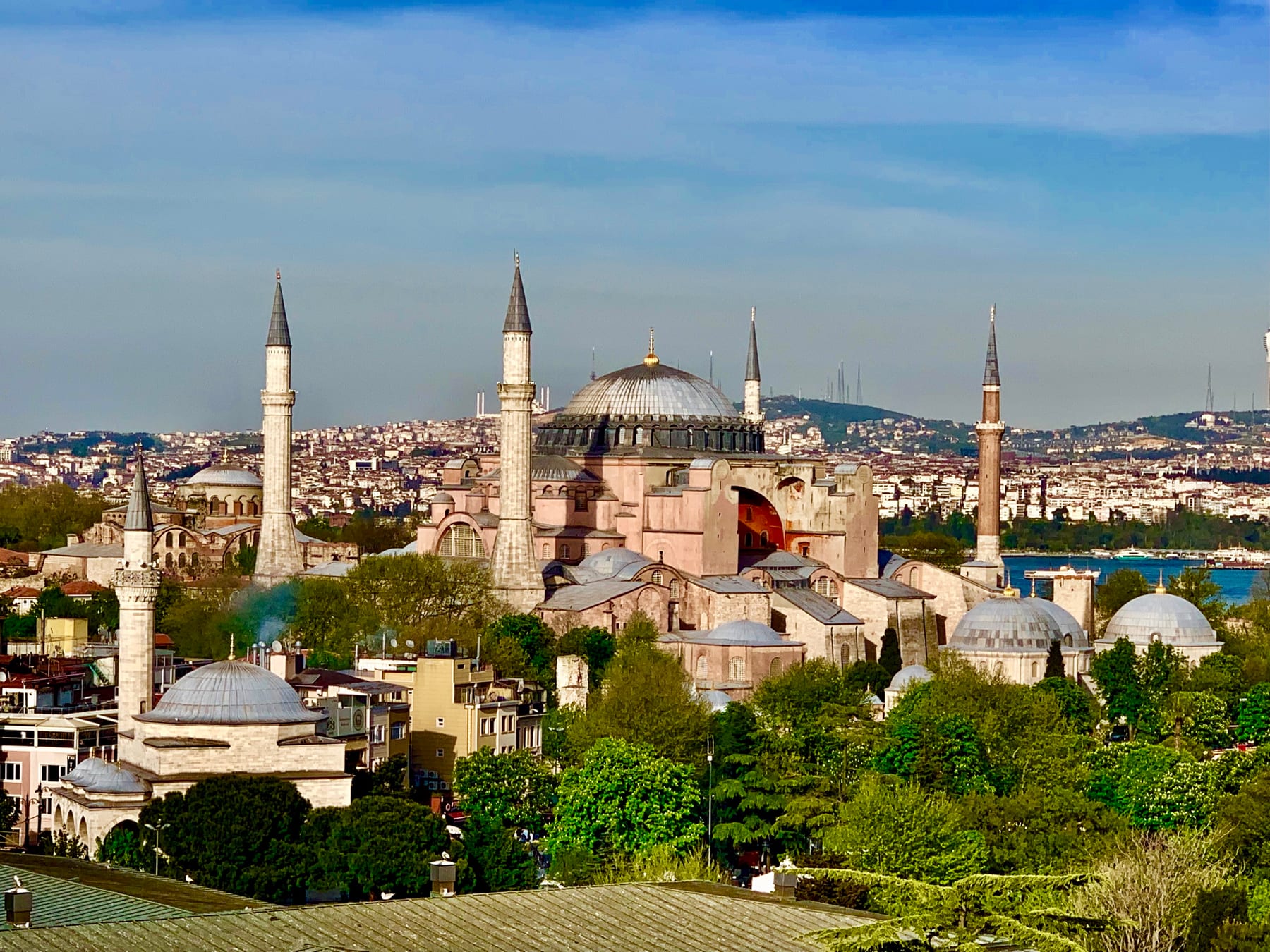 A panoramic view of Hagia Sophia and its minarets above the Istanbul Old City rooftops, the Bosphorus and the Asian shore beyond