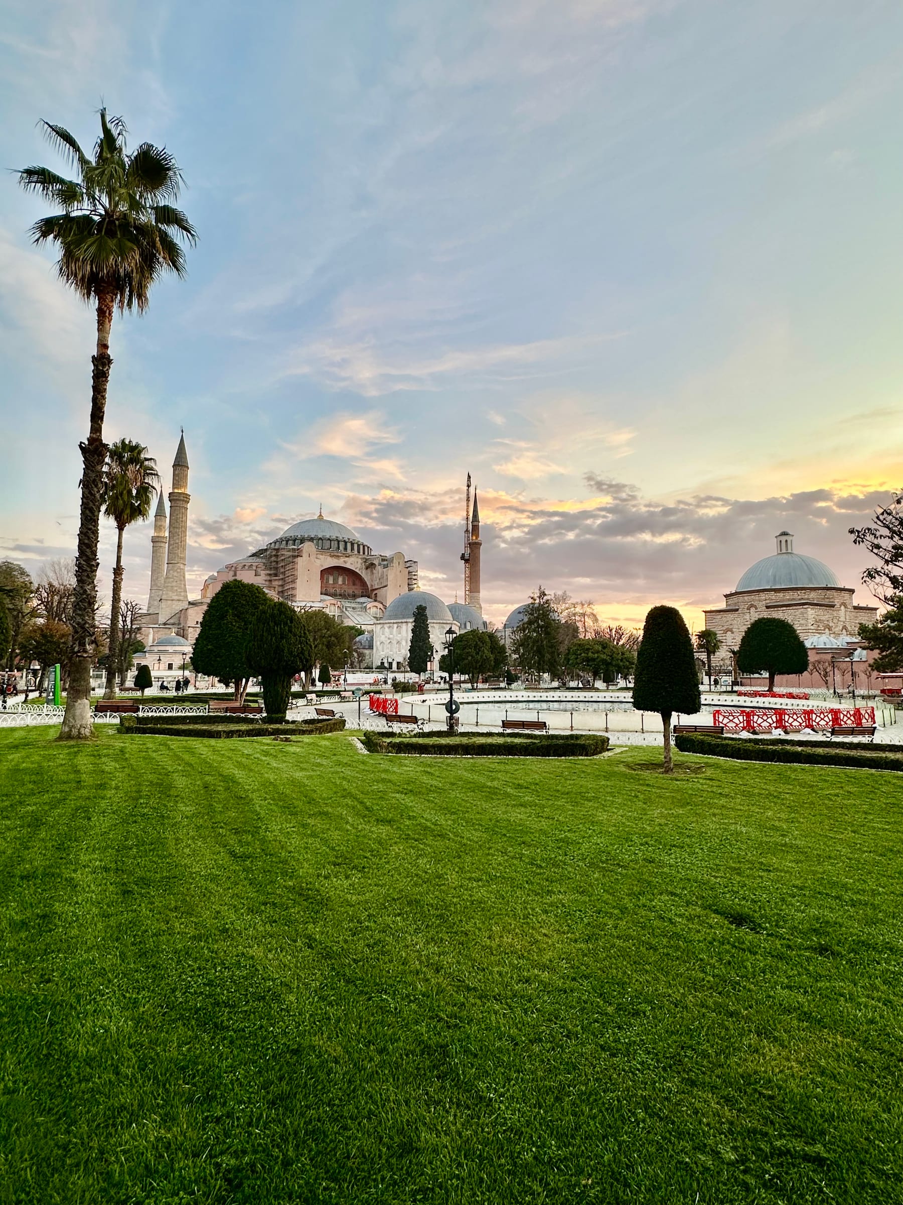 Hagia Sophia at golden hour, its domes and minarets rising above Sultanahmet in the last light of the day