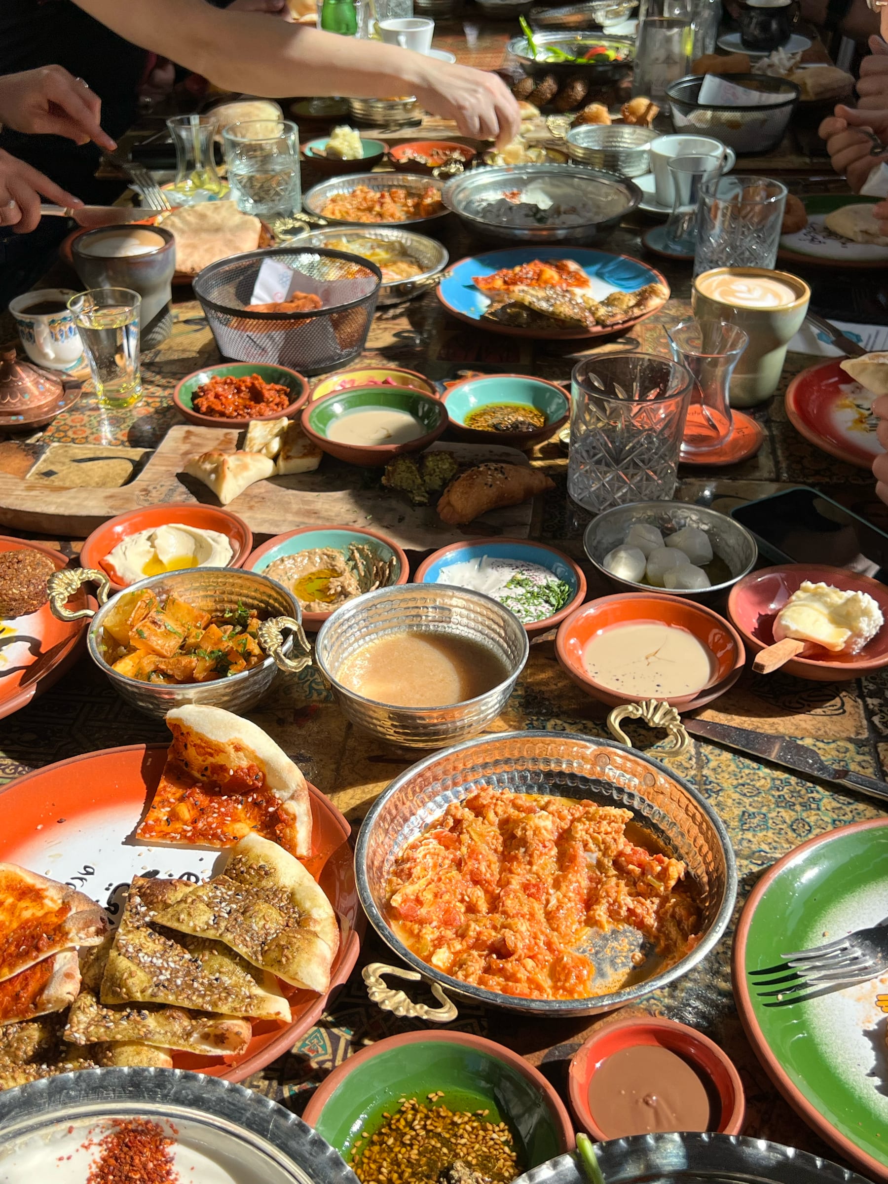 A generous spread of Turkish meze and small plates on a wooden table