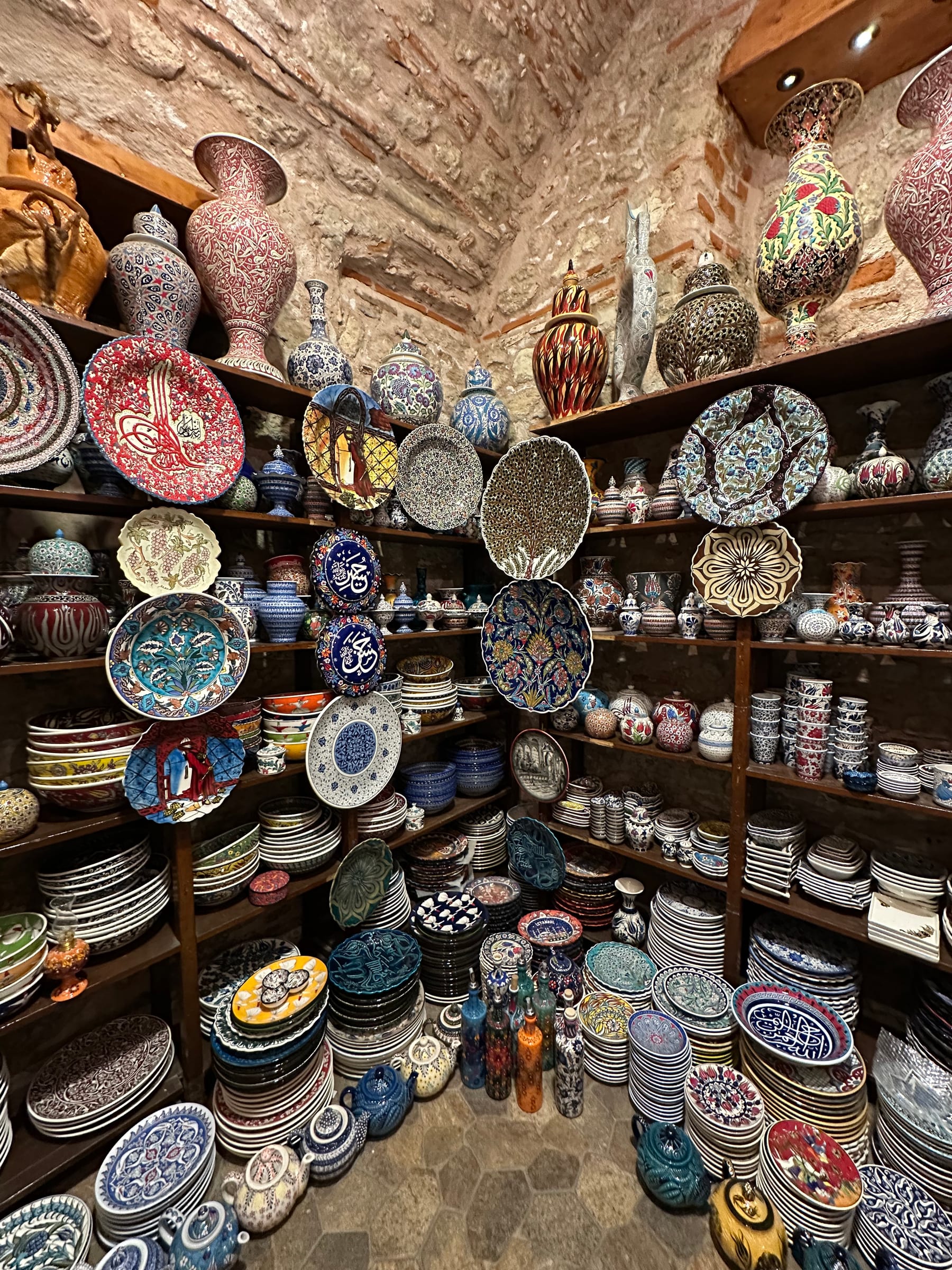 Shelves of colorful Turkish ceramic plates, bowls and vases in an Iznik-style tile shop